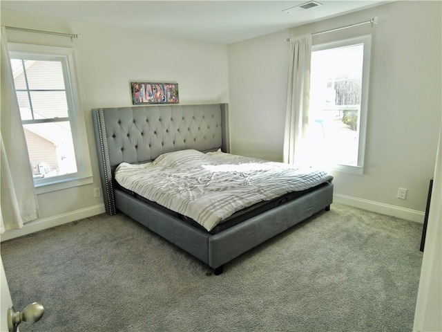 bedroom with carpet floors, baseboards, and visible vents