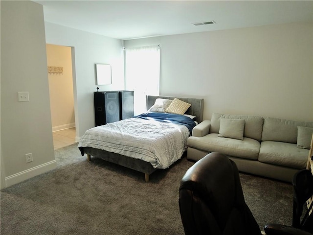 bedroom featuring visible vents, baseboards, and carpet
