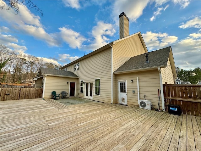 wooden deck featuring french doors, fence, and ac unit