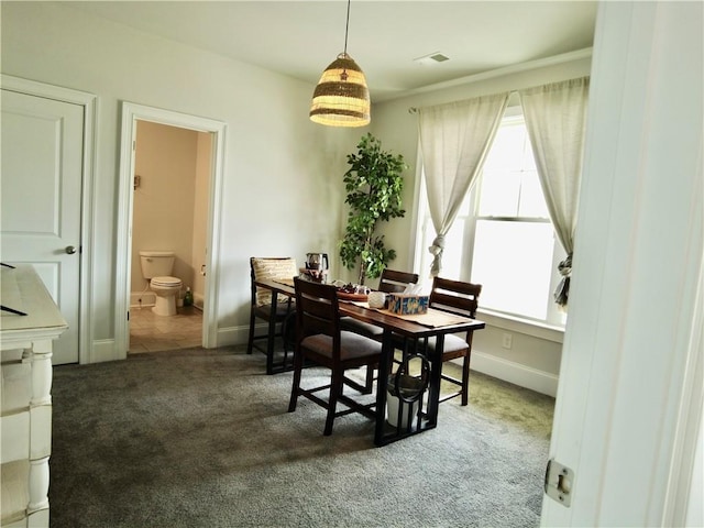 dining space with carpet flooring, baseboards, and visible vents