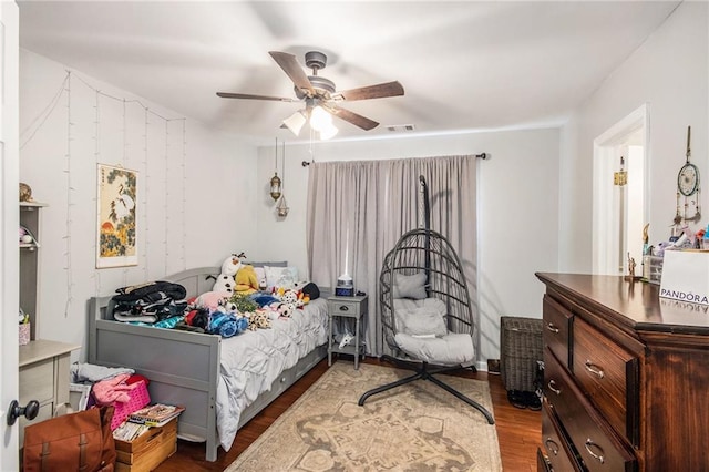 bedroom featuring visible vents, a ceiling fan, and wood finished floors