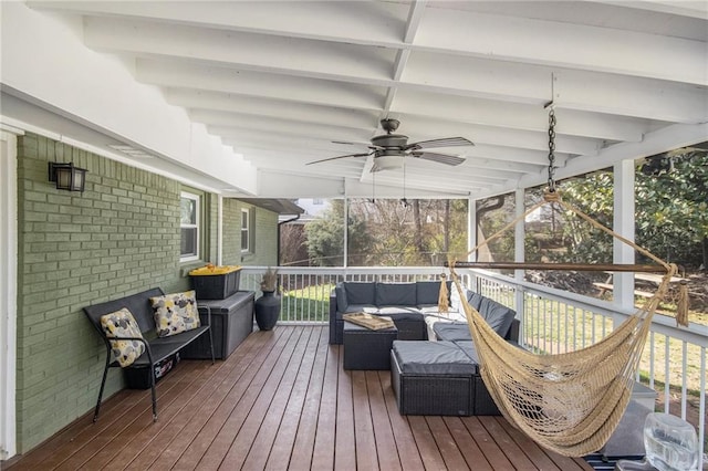 wooden terrace featuring an outdoor living space and a ceiling fan