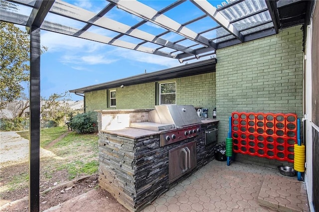 view of patio / terrace featuring area for grilling, a grill, and a pergola