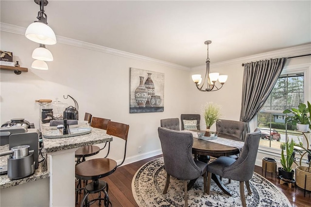 dining area with dark wood finished floors, a notable chandelier, baseboards, and ornamental molding