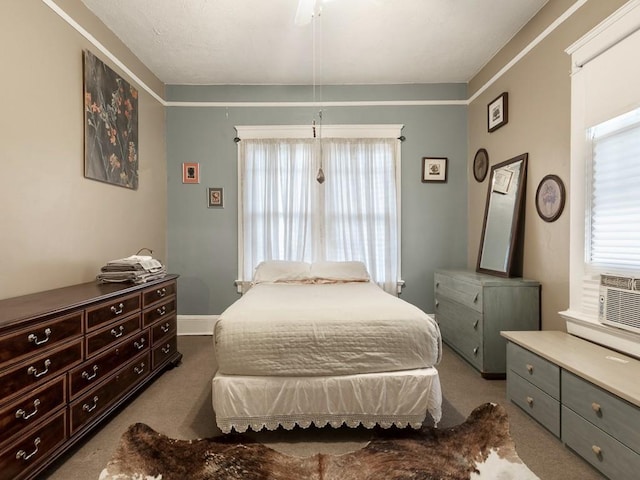 bedroom featuring ornamental molding, light carpet, and ceiling fan