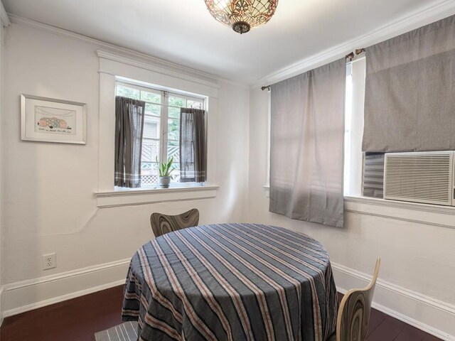 dining room featuring ornamental molding, dark hardwood / wood-style flooring, and cooling unit