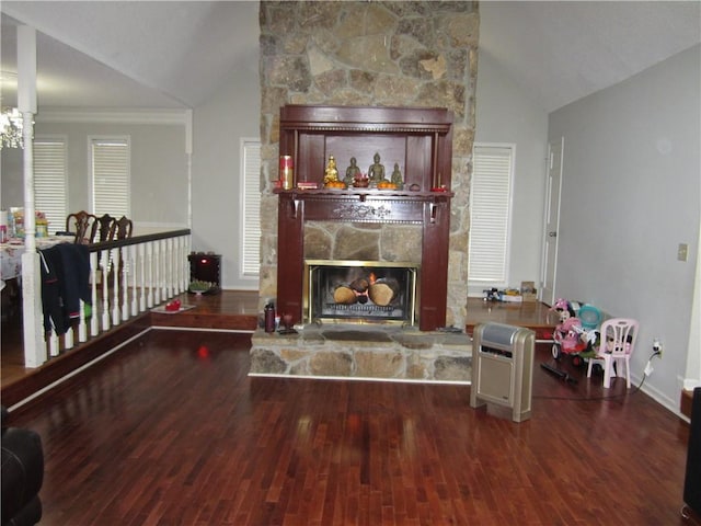 living room with dark hardwood / wood-style flooring, ornamental molding, a fireplace, and vaulted ceiling