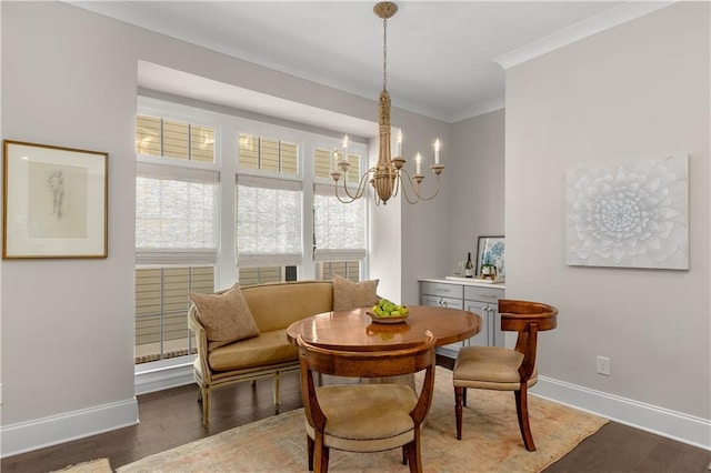 dining area featuring an inviting chandelier, dark hardwood / wood-style floors, and ornamental molding