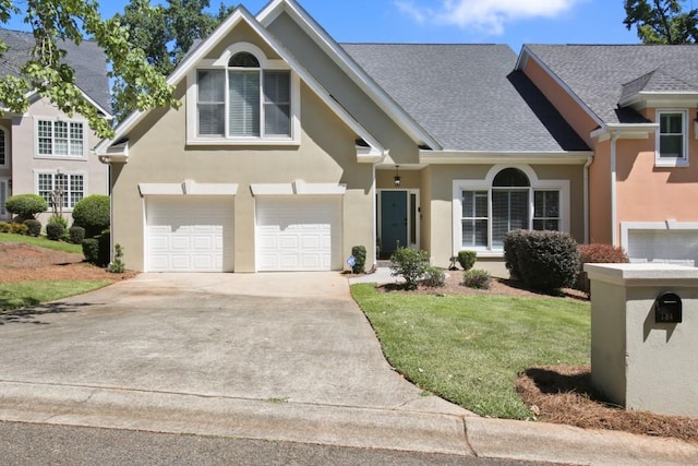 view of front of home with a front lawn and a garage