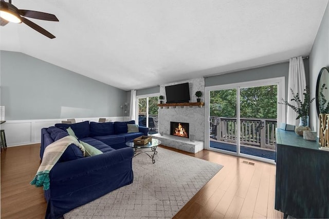 9430 Chestatee Ct, Gainesville, GA 30506 - living area with ceiling fan, a large fireplace, wood finished floors, lofted ceiling, and wainscoting