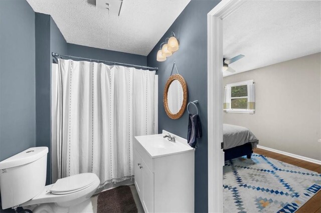 9430 Chestatee Ct, Gainesville, GA 30506 - full bathroom featuring a textured ceiling, vanity, wood finished floors, a ceiling fan, and a shower with shower curtain
