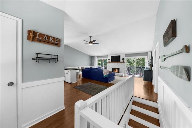 9430 Chestatee Ct, Gainesville, GA 30506 - living area featuring a large fireplace, a ceiling fan, vaulted ceiling, and dark wood-style flooring