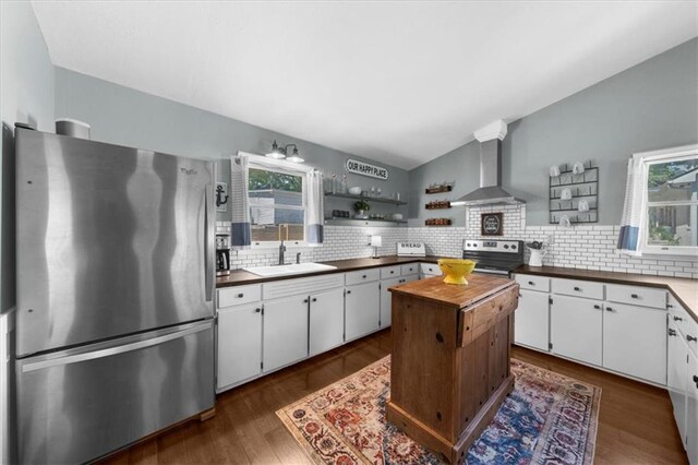 9430 Chestatee Ct, Gainesville, GA 30506 - kitchen with appliances with stainless steel finishes, wall chimney exhaust hood, open shelves, plenty of natural light, and vaulted ceiling