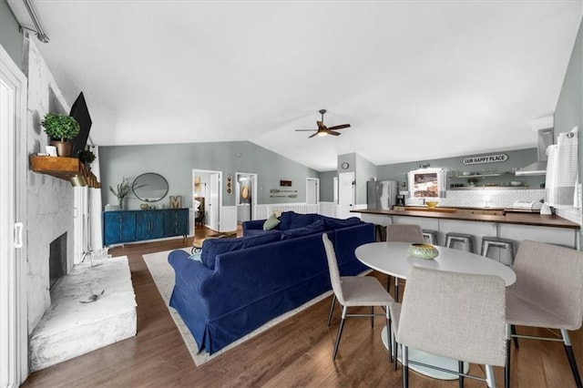 9430 Chestatee Ct, Gainesville, GA 30506 - living room featuring ceiling fan, a wainscoted wall, wood finished floors, vaulted ceiling, and a large fireplace