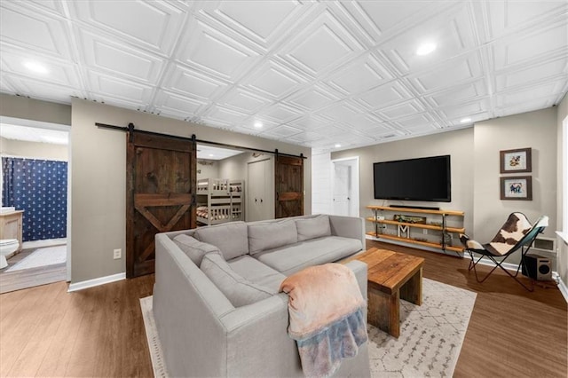 9430 Chestatee Ct, Gainesville, GA 30506 - living room with a barn door, recessed lighting, wood finished floors, and an ornate ceiling