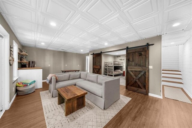 9430 Chestatee Ct, Gainesville, GA 30506 - living room featuring a barn door, light wood finished floors, recessed lighting, and an ornate ceiling