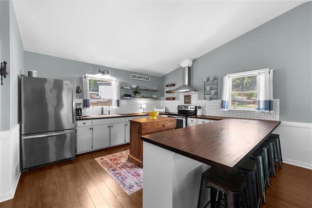 9430 Chestatee Ct, Gainesville, GA 30506 - kitchen with stainless steel appliances, wall chimney range hood, dark wood finished floors, a peninsula, and open shelves