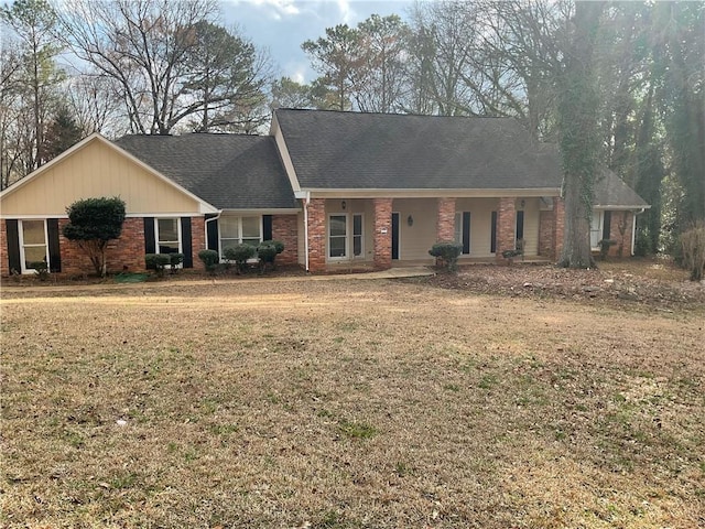 ranch-style home featuring a porch and a front yard