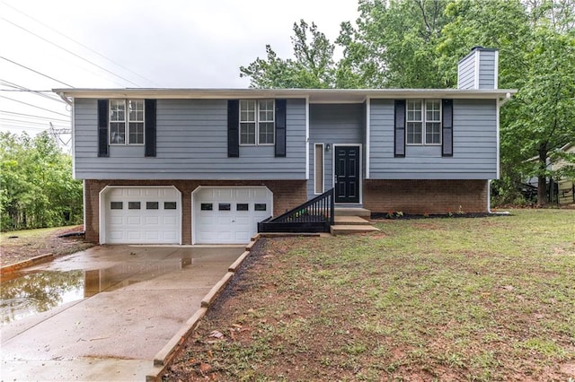 raised ranch with a garage and a front yard