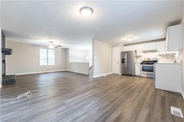 kitchen featuring white cabinets, dark wood-style floors, visible vents, and appliances with stainless steel finishes