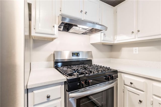 kitchen featuring white cabinetry, light countertops, stainless steel gas stove, and under cabinet range hood