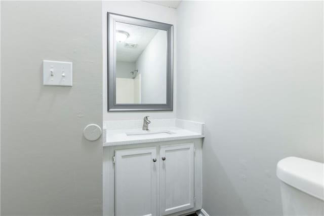 bathroom featuring toilet and vanity