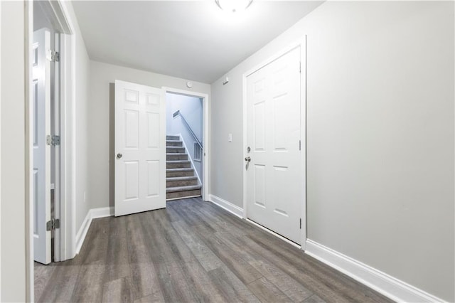 interior space with stairway, baseboards, and wood finished floors