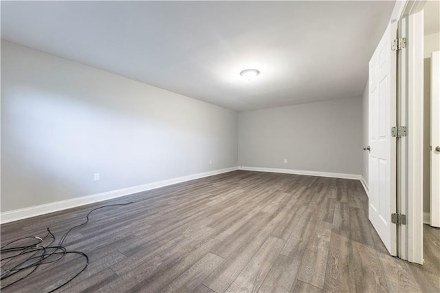 empty room with wood finished floors and baseboards