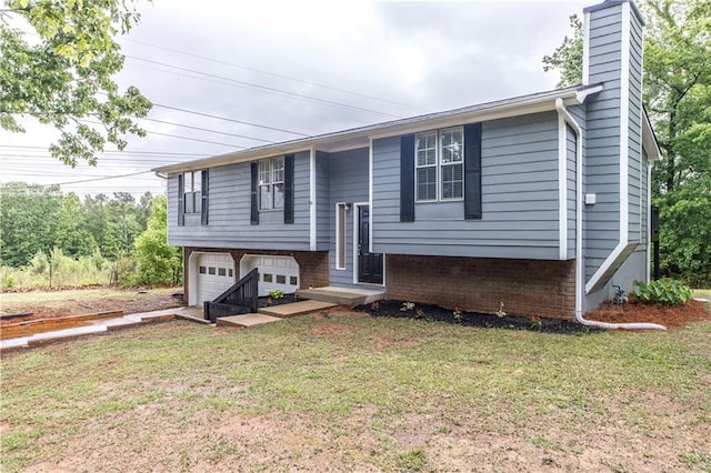 raised ranch featuring a garage and a front yard