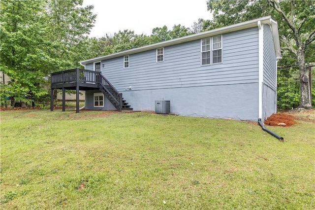 rear view of house with stairway, a yard, central AC, and a deck