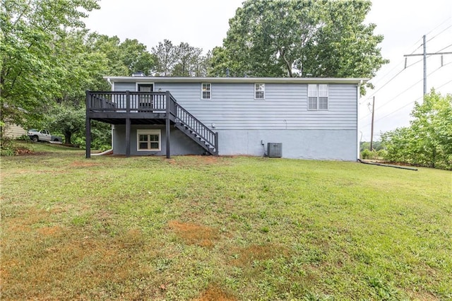 back of property with stairway, a lawn, central AC, and a deck