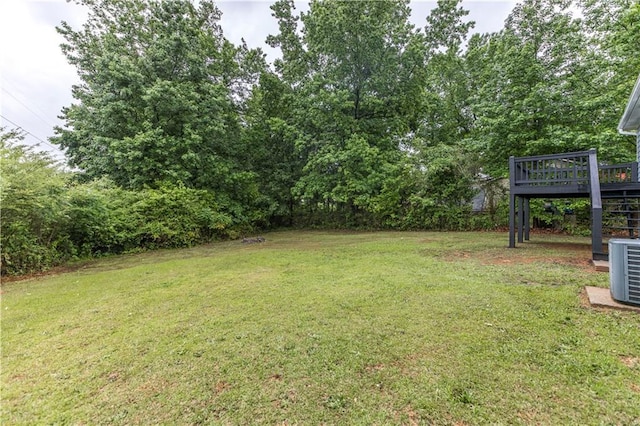 view of yard featuring stairs, central AC unit, and a wooden deck