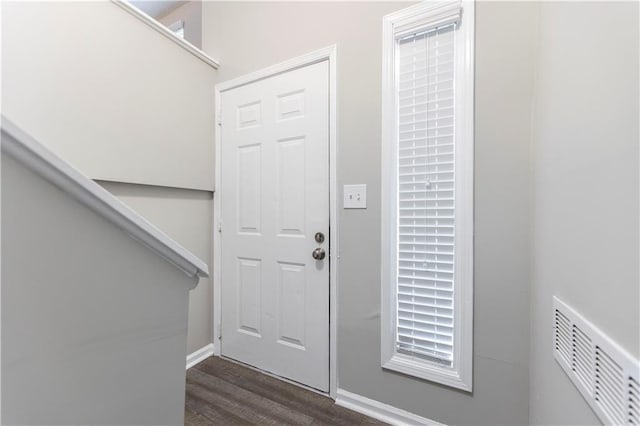 entrance foyer featuring dark wood-type flooring, baseboards, and visible vents