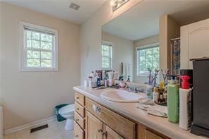 bathroom featuring tile patterned floors, vanity, and toilet