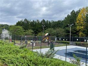 exterior space featuring a playground and tennis court