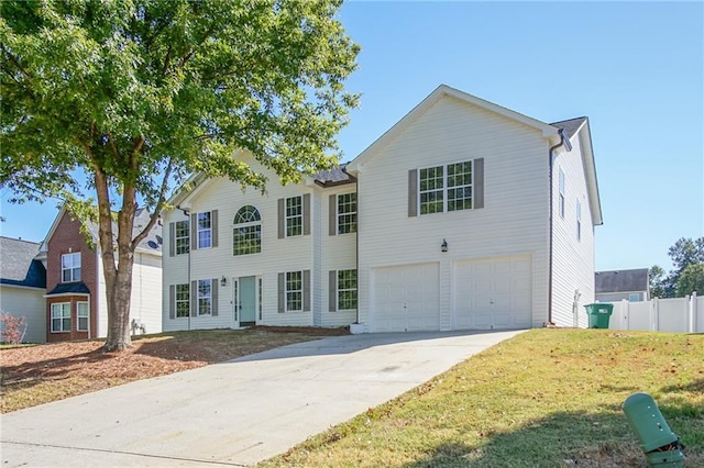 view of front of property with a front yard and a garage