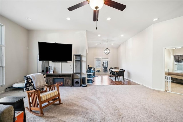 living room featuring carpet, baseboards, ceiling fan, and recessed lighting