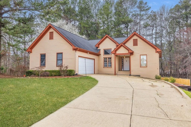 view of front of house with driveway, an attached garage, and a front lawn