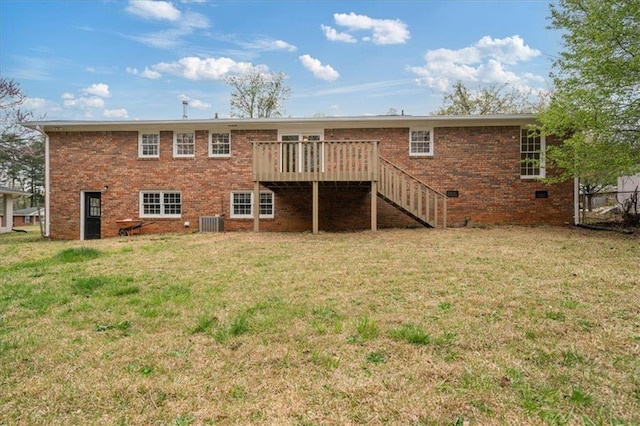 rear view of property with stairway, central air condition unit, a wooden deck, brick siding, and a lawn