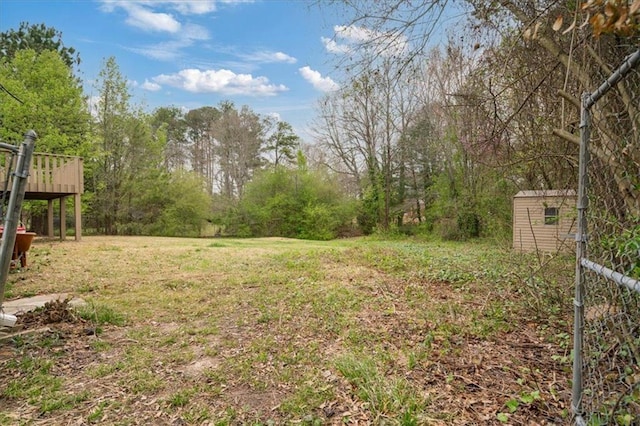 view of yard featuring an outbuilding and a deck