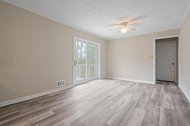 empty room with light wood-type flooring, baseboards, a textured ceiling, visible vents, and a ceiling fan
