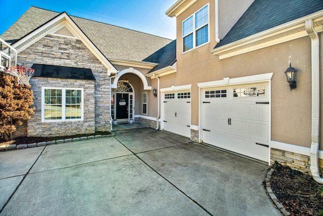 view of front facade with roof with shingles, an attached garage, stucco siding, concrete driveway, and stone siding