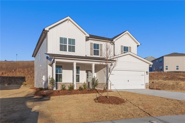 4032 Trimrose Ct, Atlanta, GA 30349 - view of front of property featuring board and batten siding, driveway, covered porch, and a garage