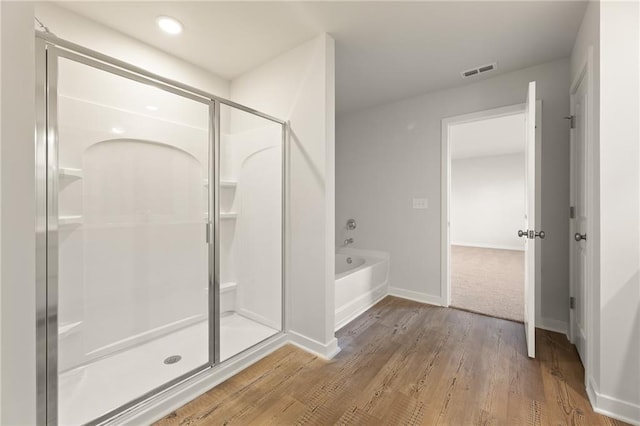 4032 Trimrose Ct, Atlanta, GA 30349 - full bathroom with a stall shower, wood finished floors, a bath, baseboards, and recessed lighting