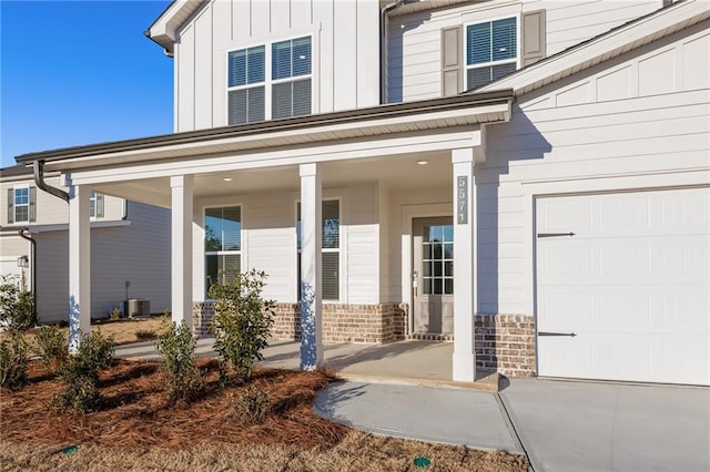 4032 Trimrose Ct, Atlanta, GA 30349 - doorway to property with covered porch, board and batten siding, and central AC