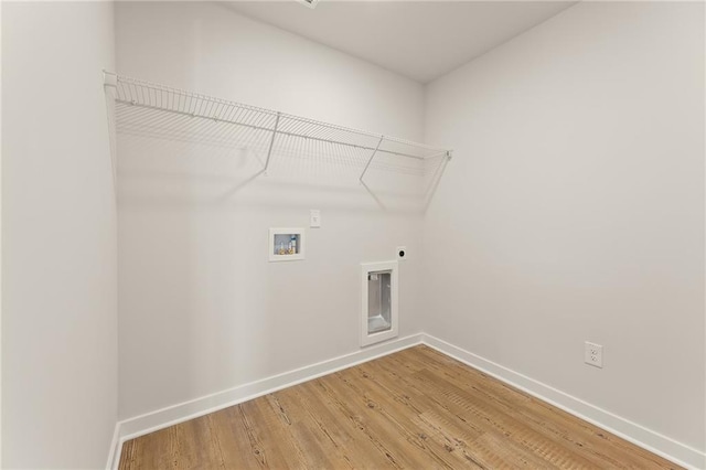 4032 Trimrose Ct, Atlanta, GA 30349 - laundry room featuring hookup for a washing machine, hookup for an electric dryer, baseboards, and light wood-style floors