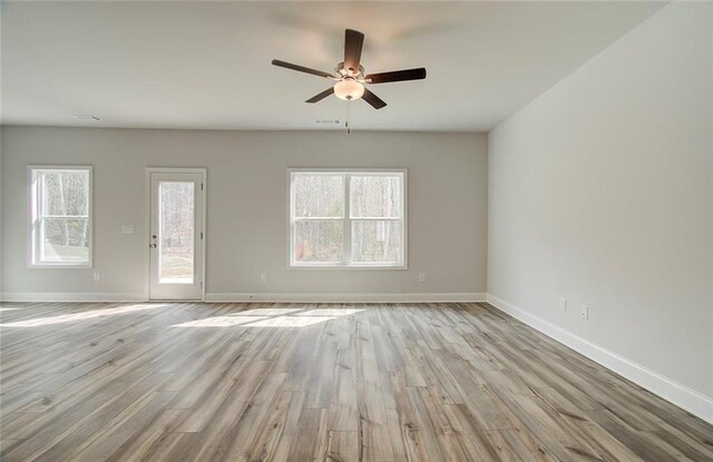 kitchen featuring a center island with sink, sink, ceiling fan, dark brown cabinets, and stainless steel appliances