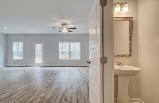 kitchen featuring light stone countertops, an island with sink, decorative light fixtures, and appliances with stainless steel finishes