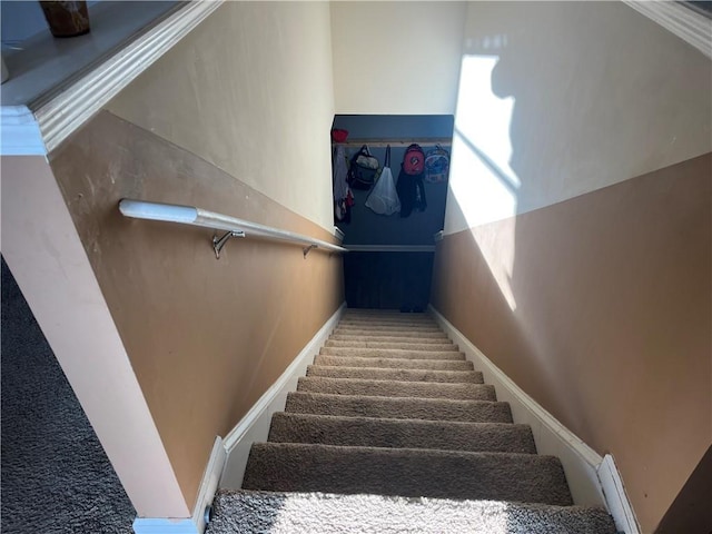 staircase featuring baseboards