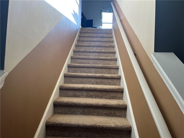 staircase featuring baseboards